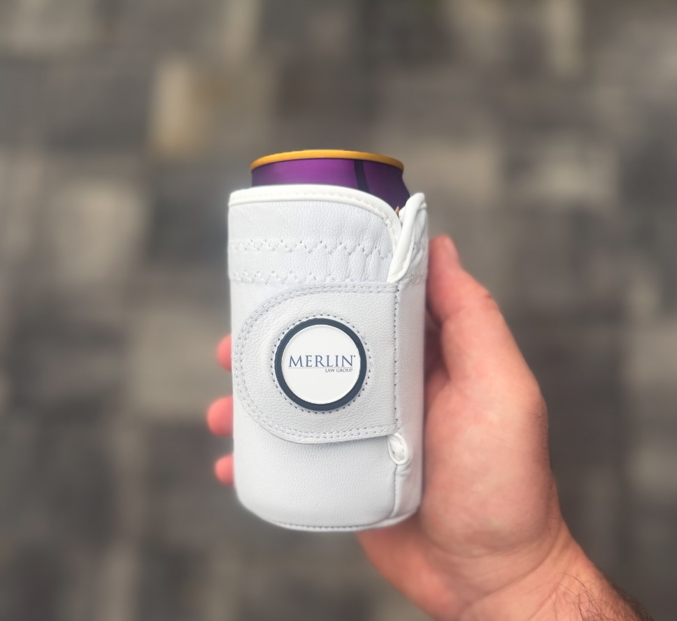 A branded Gloozie held in hand, showing the drink sleeve and magnetic ball marker